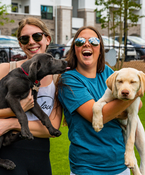 Women holding their dogs